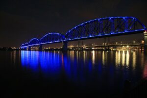 Big Four bridge across Ohio River lit up with blue lights