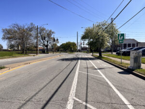 Bike Lane near intersection of 13th Street and Chestnut Street. Bike lane indicated with white lines and wider white line lane markings for area between cars and bike lane.