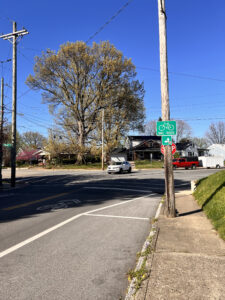 Bike Route green street sign near Ellison Avenue and Spratt Street intersection. Bike route sharrows lane marking on pavement.