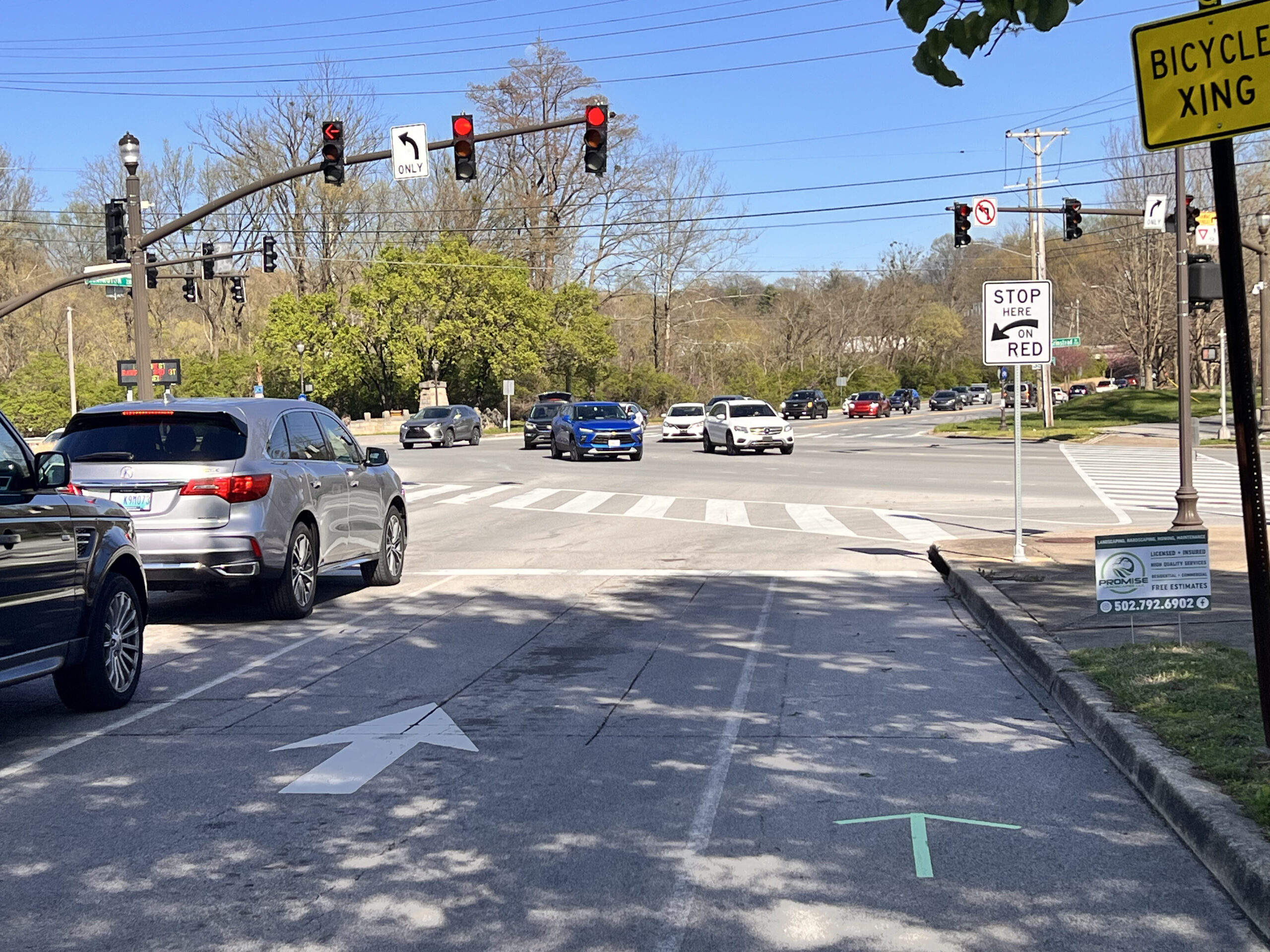 Traffic at Lexington Road and Grinstead Drive. Line of cars making left hand turn.