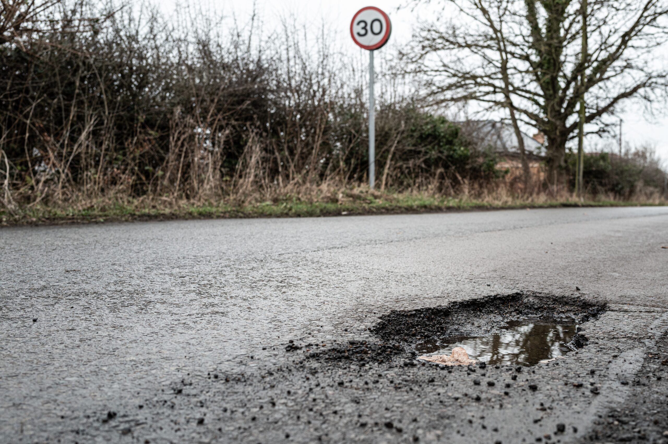 Kaufman & Stigger, PLLC | Bicycle Accidents Caused by Potholes in Kentucky - Deep,Road,Pothole,Filled,With,Rainwater.,Already,Filled,Once,,The
