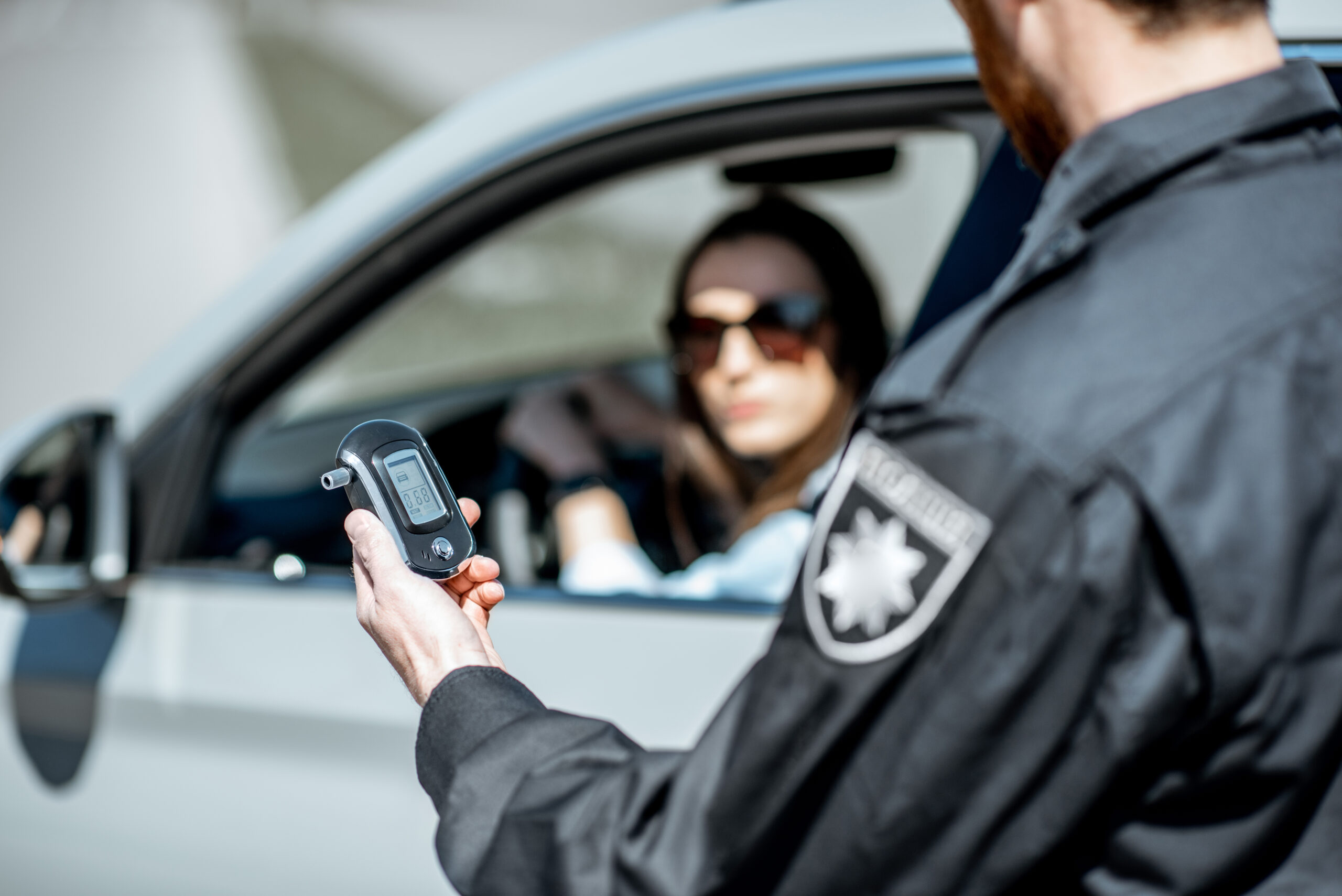 Kaufman & Stigger, PLLC | Car Accidents Caused by Driving While Intoxicated in Kentucky - Policeman,Holding,Device,For,Checking,Alcohol,Intoxication,While,Standing,Near