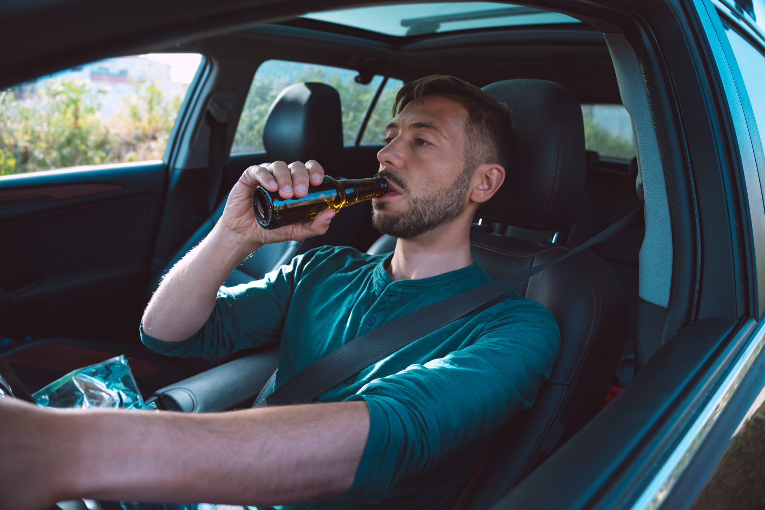 Kaufman & Stigger, PLLC | Accidents Caused by Drunk Drivers in Kentucky - Drunk,Driver.,Young,Man,Drinking,Beer,While,Driving,A,Car.
